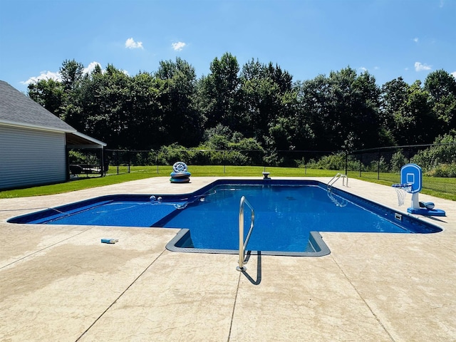 view of swimming pool featuring a patio and a lawn