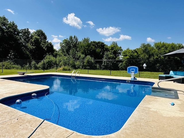 view of swimming pool with a lawn