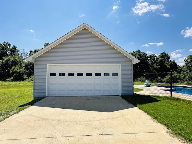 garage featuring a lawn