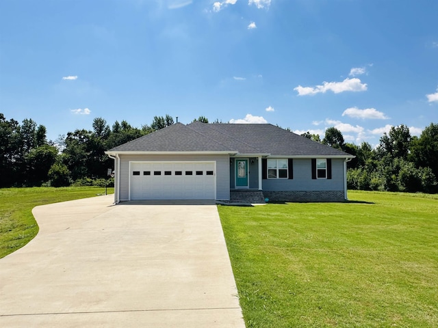 view of front of property with a garage and a front lawn