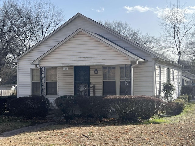 bungalow-style house with a front lawn