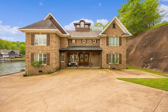 view of front of property featuring a water view and covered porch