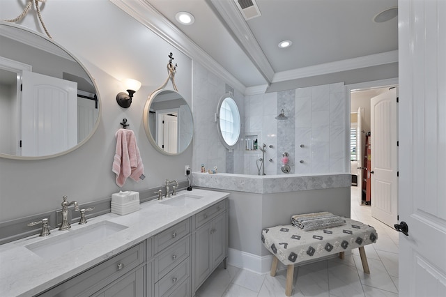 bathroom with crown molding, vanity, and a tile shower