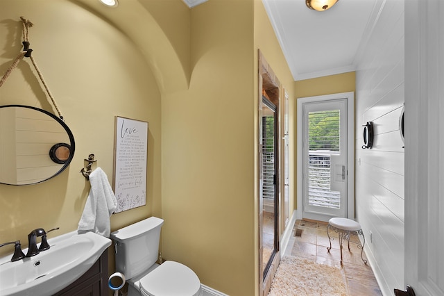 bathroom with vanity, crown molding, and toilet