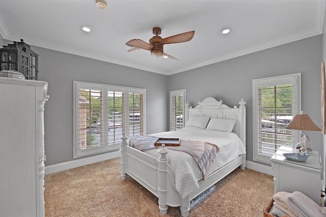 carpeted bedroom featuring ornamental molding and ceiling fan