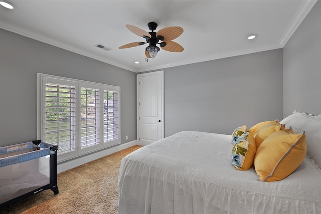 carpeted bedroom with ceiling fan and ornamental molding