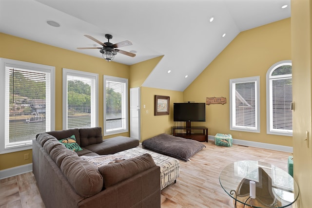 living room with lofted ceiling, light hardwood / wood-style floors, and ceiling fan