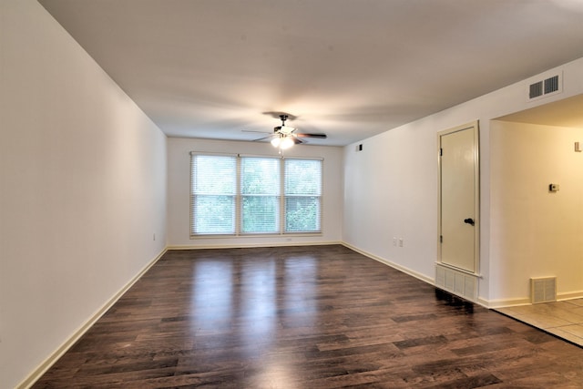 spare room with ceiling fan and dark hardwood / wood-style flooring