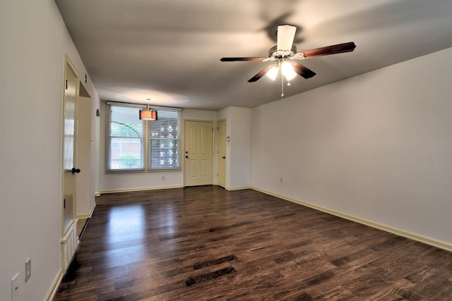 empty room with dark wood-type flooring and ceiling fan