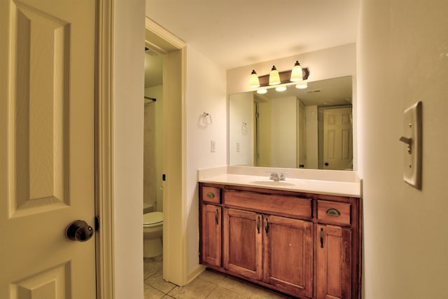 bathroom featuring tile patterned flooring, vanity, and toilet