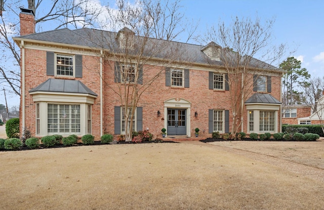 colonial-style house with a front yard