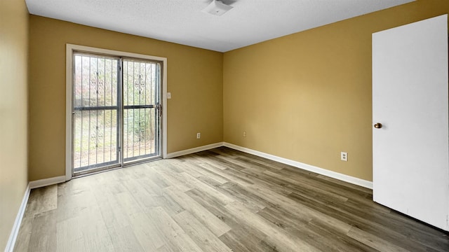 3709 Firethorne Dr, Memphis, TN 38115 - unfurnished room featuring a textured ceiling and light hardwood / wood-style floors