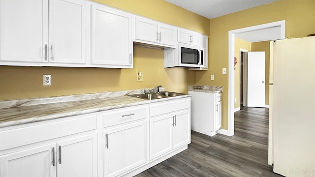 3709 Firethorne Dr, Memphis, TN 38115 - kitchen with white cabinetry, sink, and dark wood-type flooring