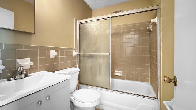 3709 Firethorne Dr, Memphis, TN 38115 - full bathroom with toilet, combined bath / shower with glass door, tile walls, a textured ceiling, and vanity