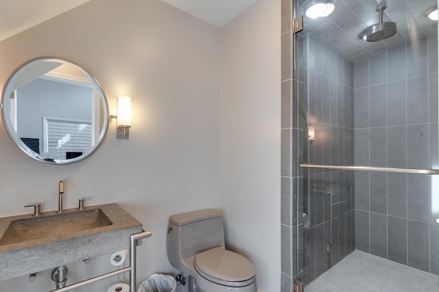 bathroom featuring vanity, toilet, and an enclosed shower