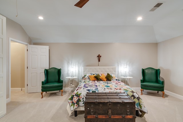 bedroom with vaulted ceiling and light carpet