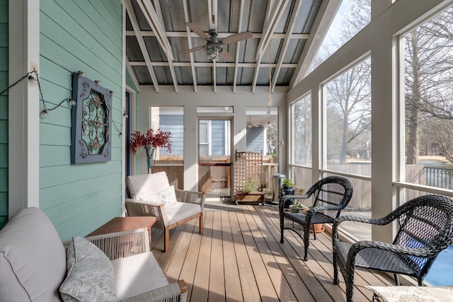 sunroom featuring ceiling fan and vaulted ceiling with beams