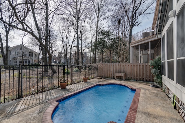 view of swimming pool with a sunroom