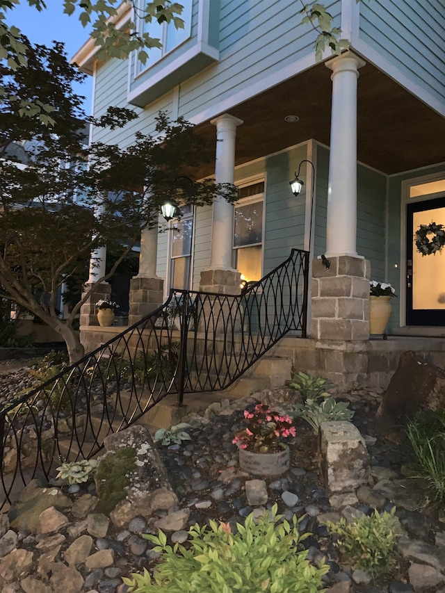 view of side of home featuring covered porch