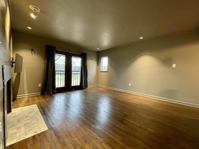 spare room with dark hardwood / wood-style floors