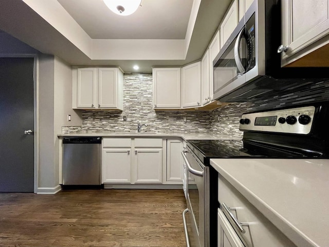 kitchen featuring white cabinetry, appliances with stainless steel finishes, and dark hardwood / wood-style floors