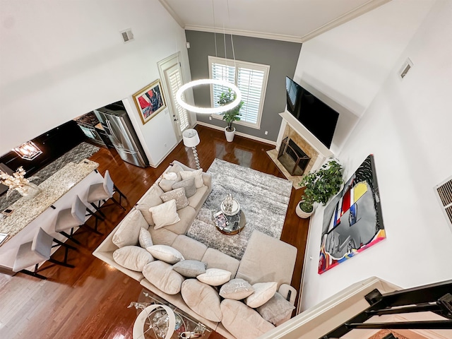 living room featuring crown molding, dark hardwood / wood-style floors, and high vaulted ceiling