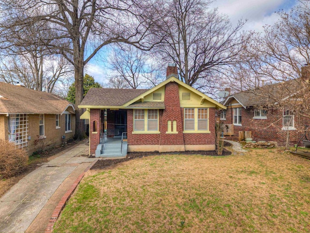 single story home with covered porch and a front lawn