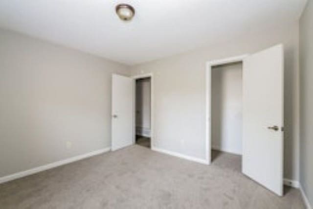 unfurnished bedroom featuring light colored carpet