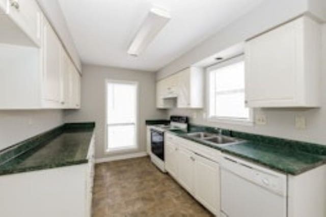 kitchen with white cabinetry, sink, and white appliances