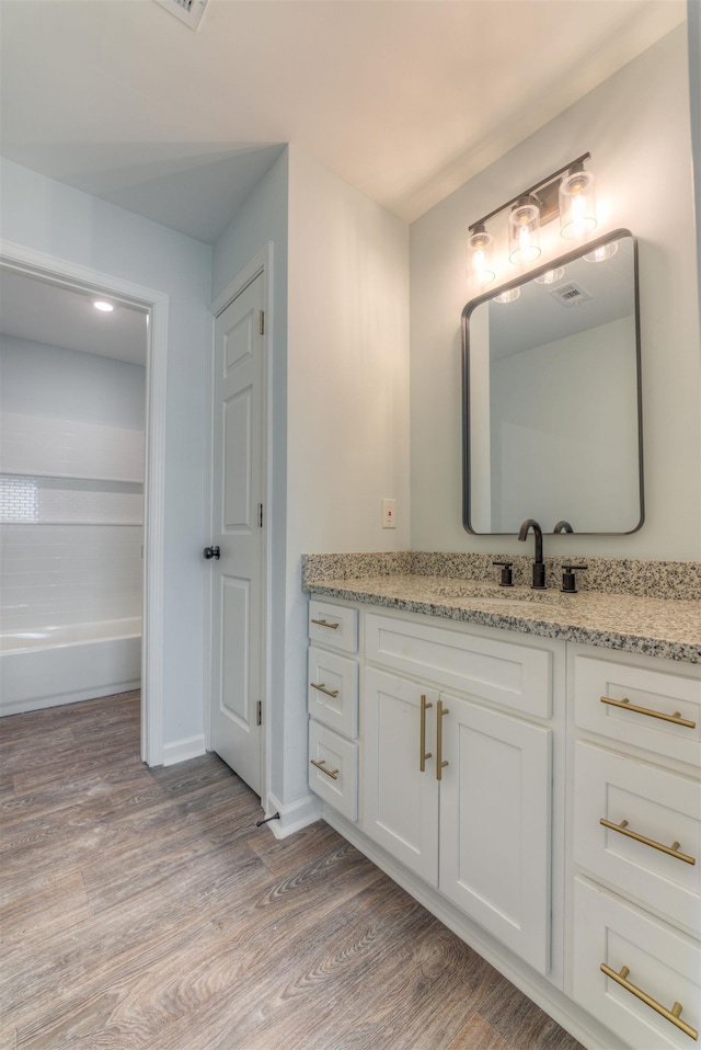 bathroom with vanity and hardwood / wood-style floors