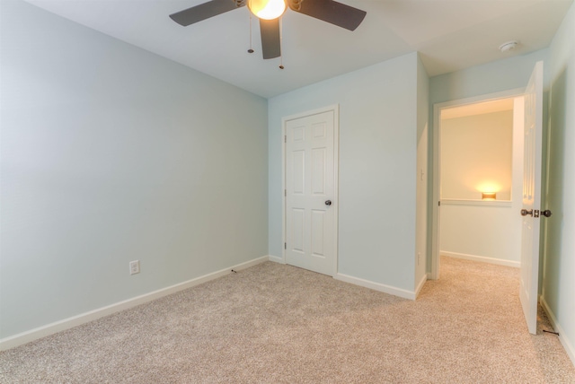 unfurnished bedroom featuring light carpet and ceiling fan