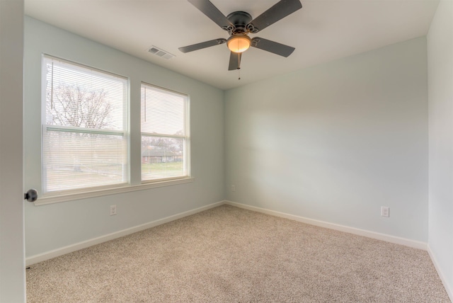 carpeted spare room with ceiling fan