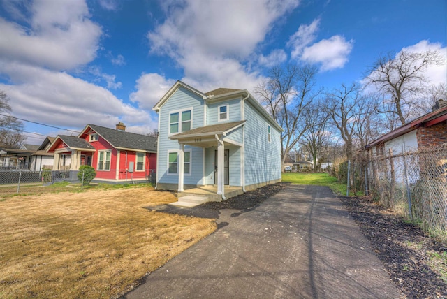 view of front of property with a front yard and covered porch