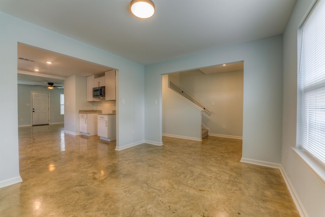 unfurnished living room with ceiling fan