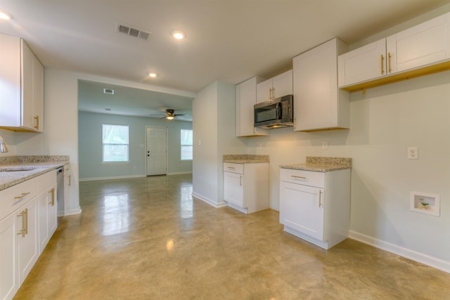 kitchen with sink, dishwasher, and white cabinets