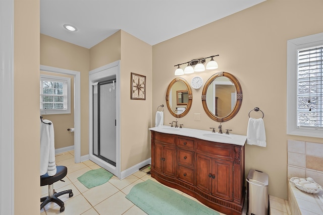 bathroom featuring tile patterned flooring, vanity, and a shower with shower door