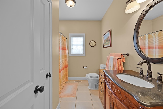 bathroom featuring vanity, tile patterned floors, and toilet