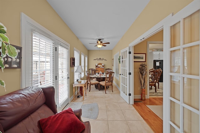 sunroom with ceiling fan and french doors