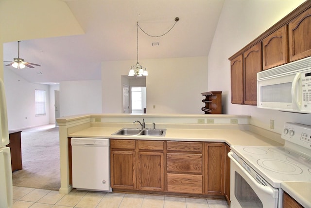 kitchen featuring vaulted ceiling, ceiling fan with notable chandelier, decorative light fixtures, sink, and white appliances