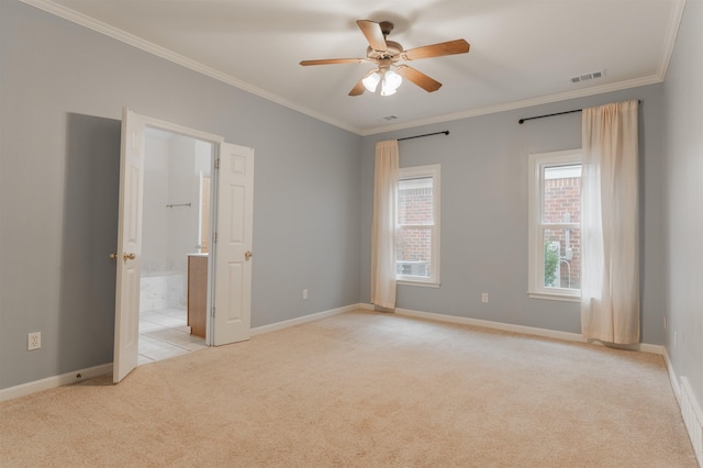 carpeted spare room featuring crown molding and ceiling fan