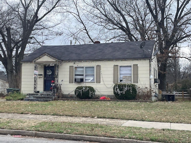 bungalow-style home with central AC and a front yard