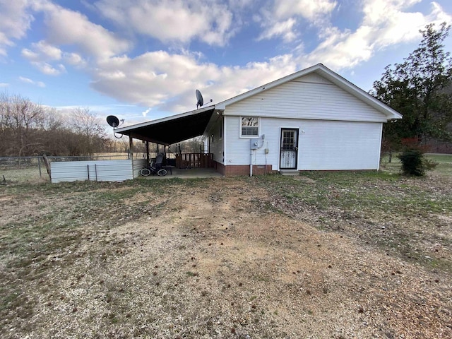 rear view of property featuring a carport