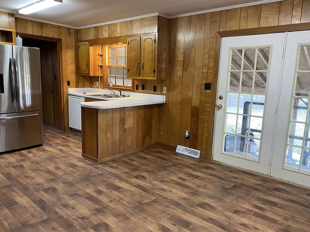 kitchen with stainless steel refrigerator with ice dispenser, white dishwasher, kitchen peninsula, and dark wood-type flooring