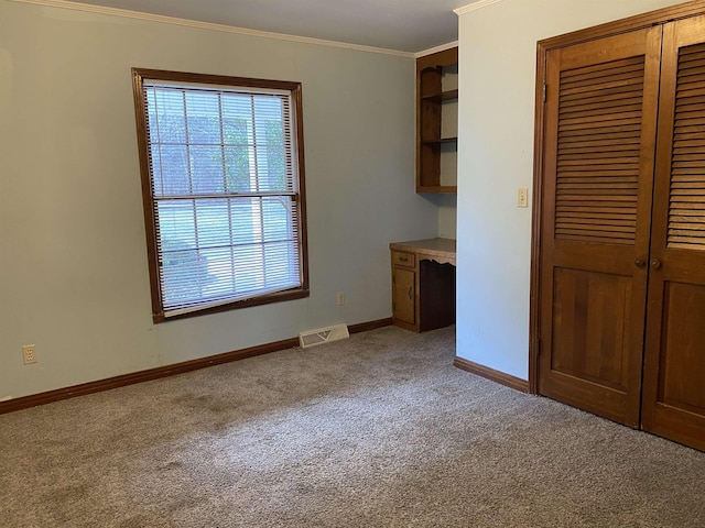 interior space featuring crown molding and light carpet