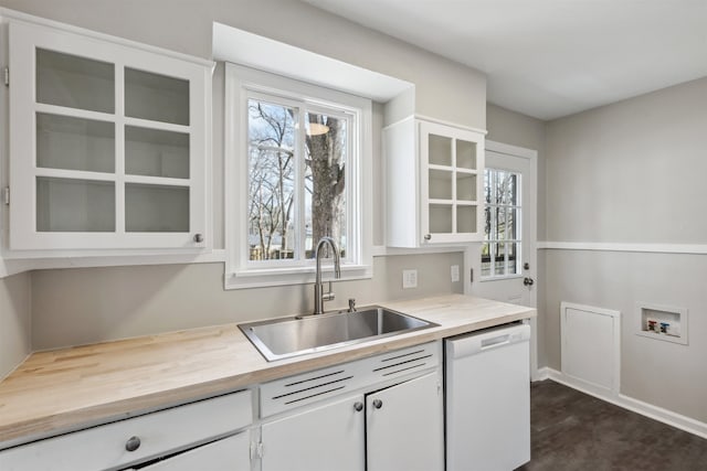 kitchen featuring dishwasher, sink, and white cabinets