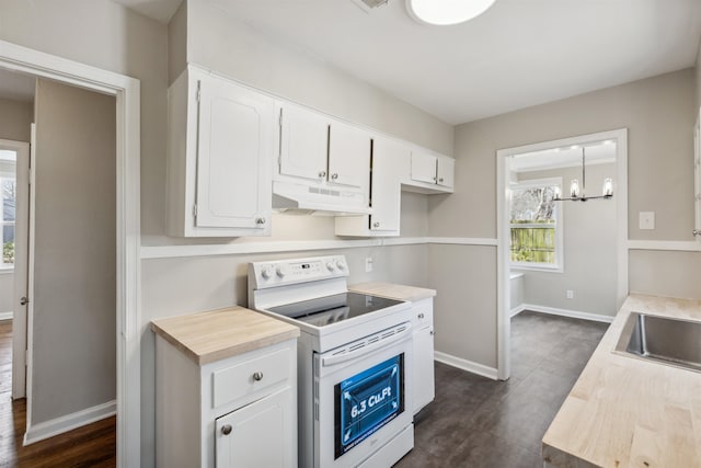 kitchen featuring white electric range oven, sink, white cabinetry, a notable chandelier, and pendant lighting