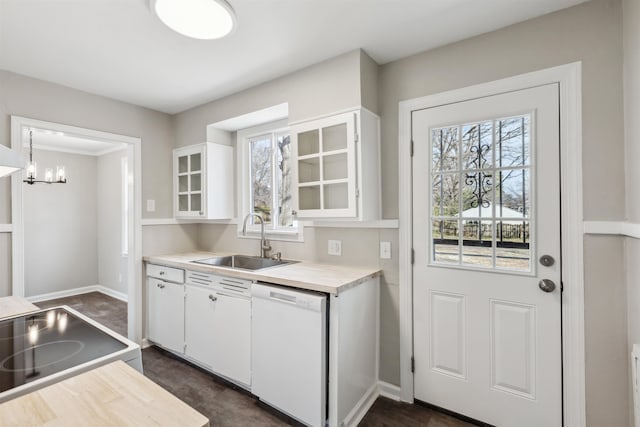 kitchen featuring white cabinetry, stove, sink, and white dishwasher