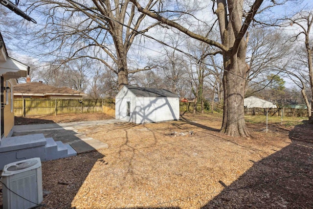 view of yard featuring central AC and a storage shed