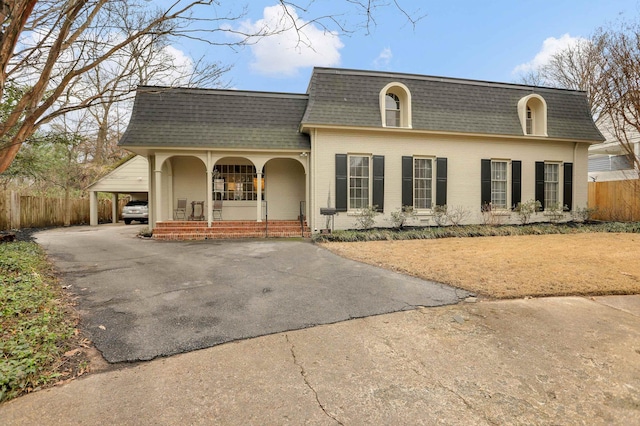 view of front of property featuring a carport and a porch