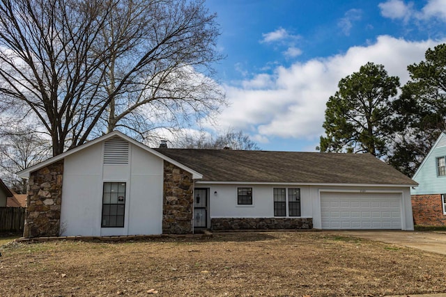 single story home featuring a garage and a front lawn